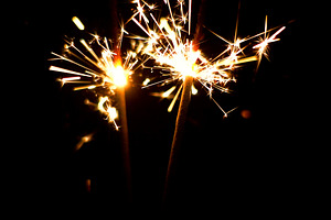 Burning Sparklers. Christmas lights.