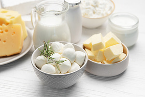 Assorted dairy products including milk, cheese, and butter, a Food & Drink Photo by Olena Rudo