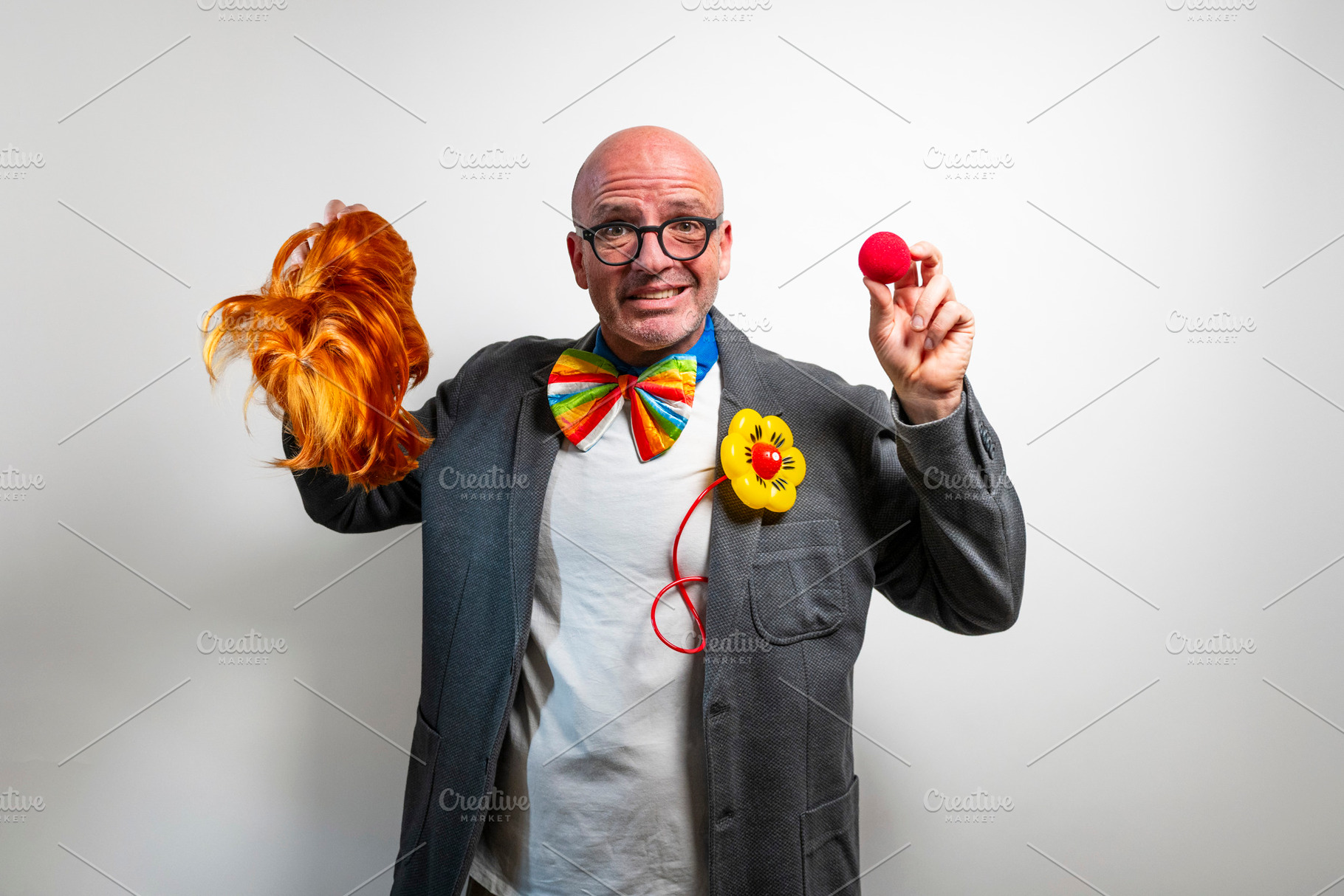 Performer with red wig and clown nose ready for show, a Person Photo by karrastock