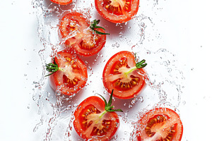 Ripe tomatoes slices with water spla, a Food & Drink Photo by Pixeness Studio