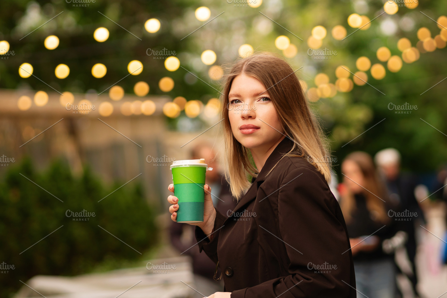 Young woman holding coffee, a Person Photo by Elena Vagengeim