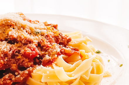 Pasta with bolognese sauce and parmesan cheese, homemade food an, a Food & Drink Photo by Anneleven