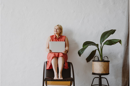 Young woman sitting on chair using