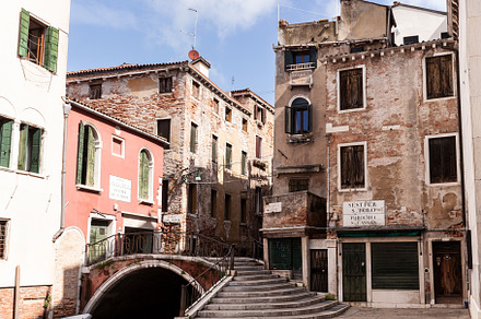 Typical bridge made with red bricks on the typical canal in Venice, an Architecture Photo by Bepslabor