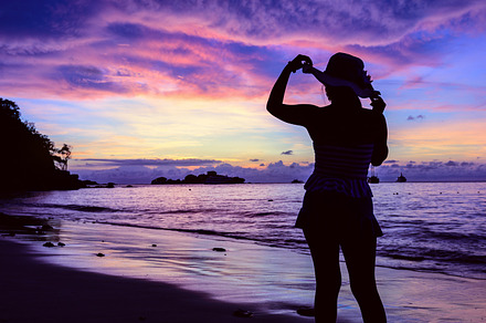 Girl on the beach at sunrise containing beach, sunrise, and sea, a Person Photo by yongkiet jitwattanatam