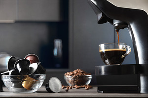 Capsule coffee machine preparing espresso in a dark kitchen, a Food & Drink Photo by Davizro's Market