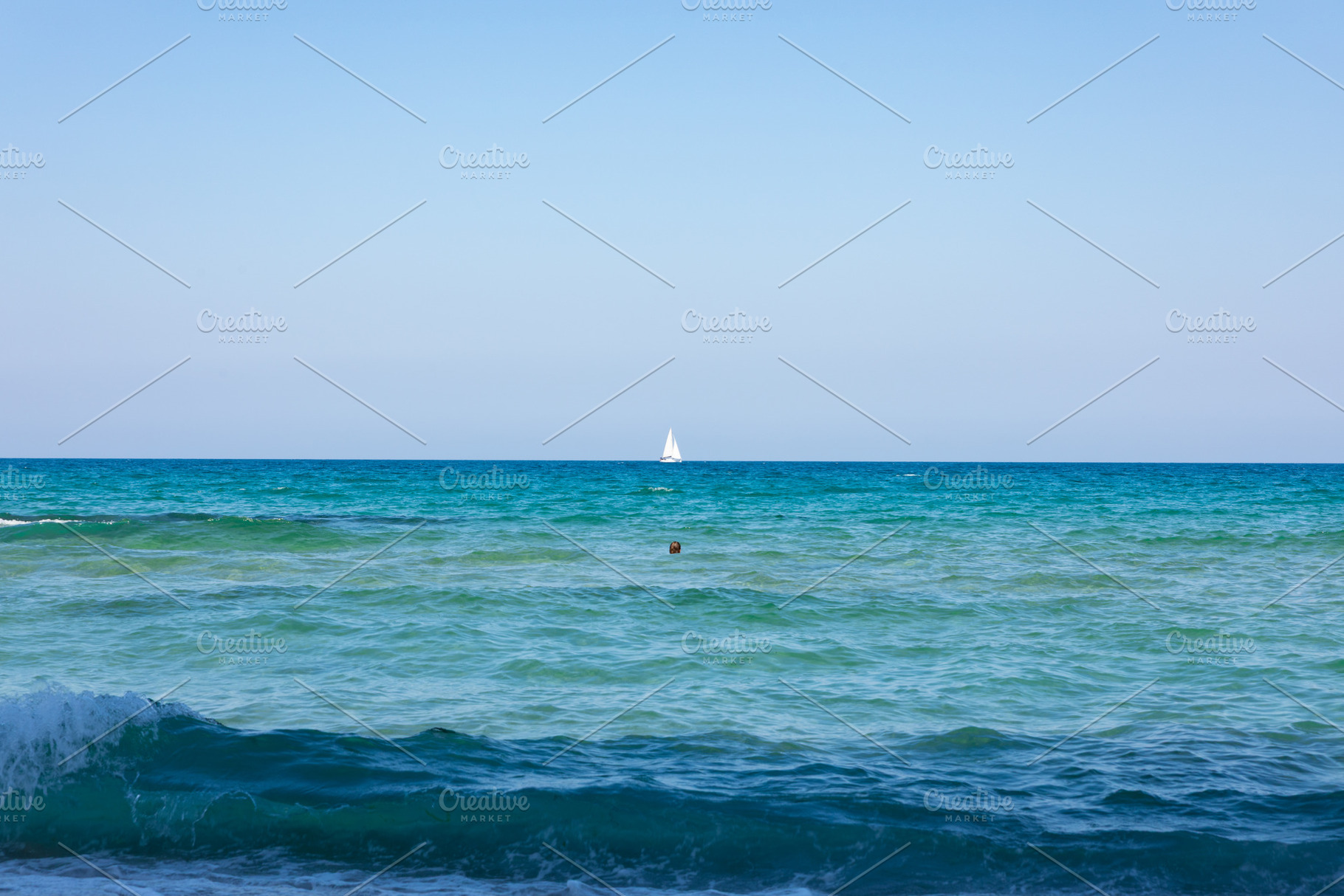 Minimalist seascape with a small white sailboat on the horizon under a clear bl, a Transportation Photo by Ales Munt