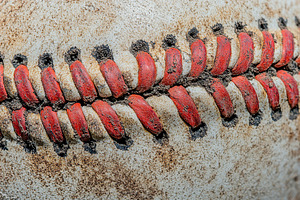 Closeup of red seam leather baseball, a Sports & Recreation Photo by AlyaAnd
