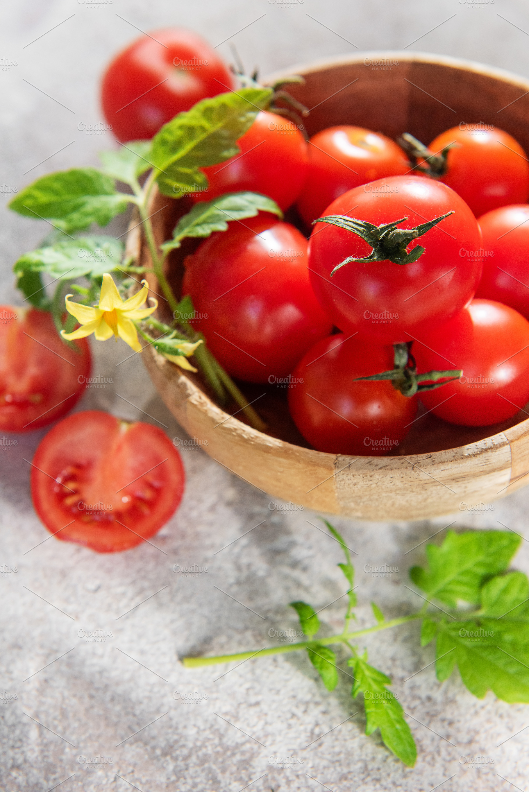 Fresh ripe cherry tomatoes with leaves and flower, a Food & Drink Photo by Olena Rudo