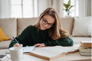 Young female student sitting on, a Person Photo by HalfPoint