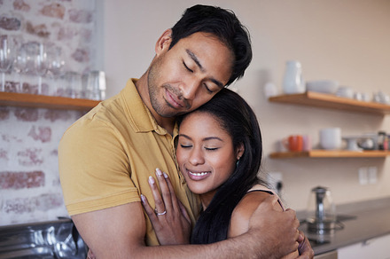 Care, love and happy couple hug and relax at home enjoying quality time together. Loving and romantic lovers bonding and cuddling in the house expressing feelings of happiness, smile and romance, a Photo by Peopleimages.com