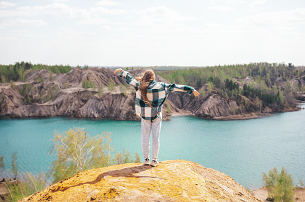 Happy teen girl on the top of mounting and feeling free and looking at the blue, a Person Photo by travnikovstudio