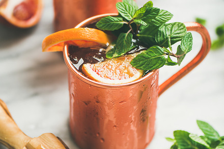 Blood orange Moscow mule alcohol cocktails in mugs, a Food & Drink Photo by Foxys