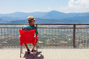 Teenager looking at mountain scenery, a Person Photo by BOOCYS