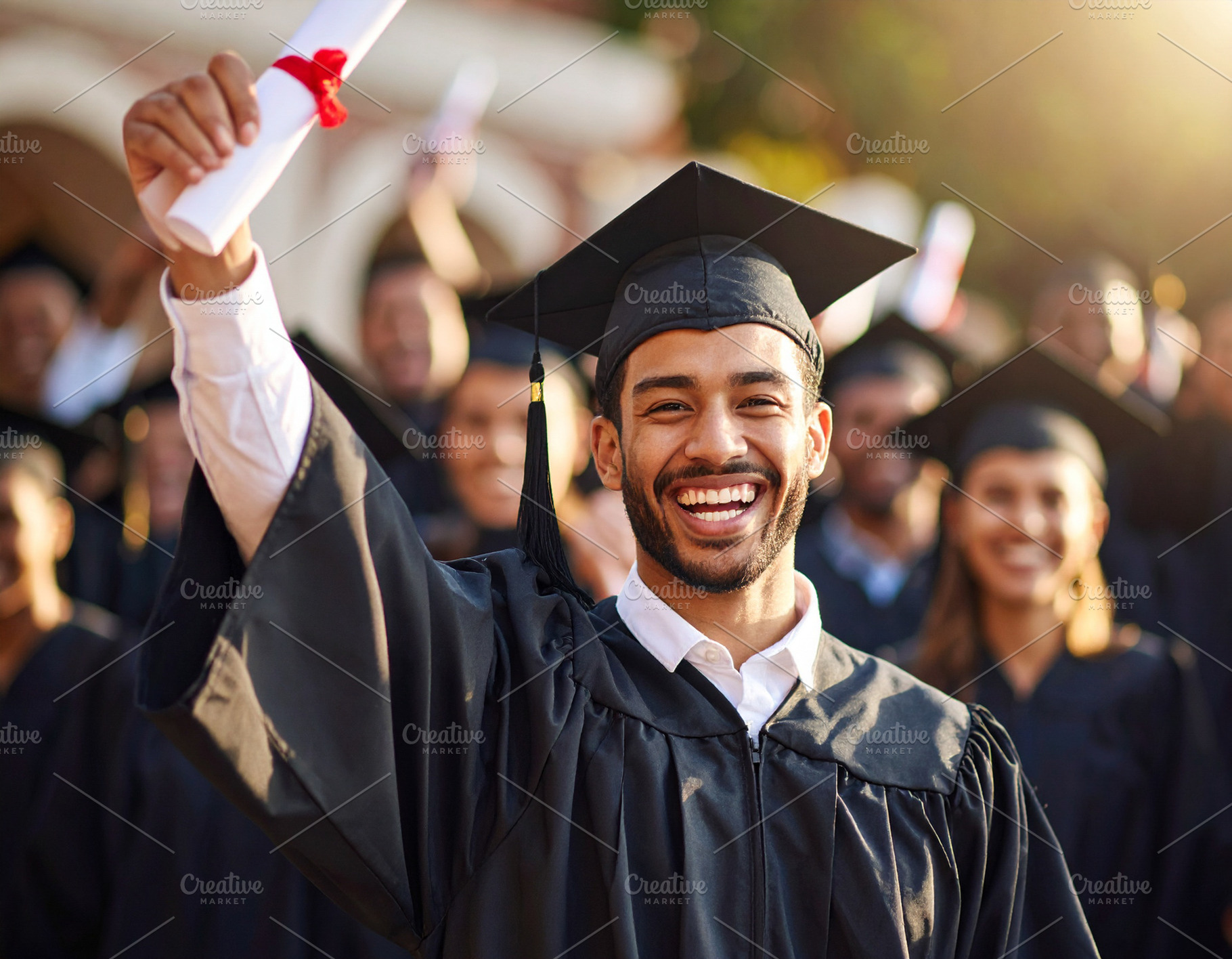 Student receiving a diploma and raising arms in success, a School & Education Photo by DanFLCreativo
