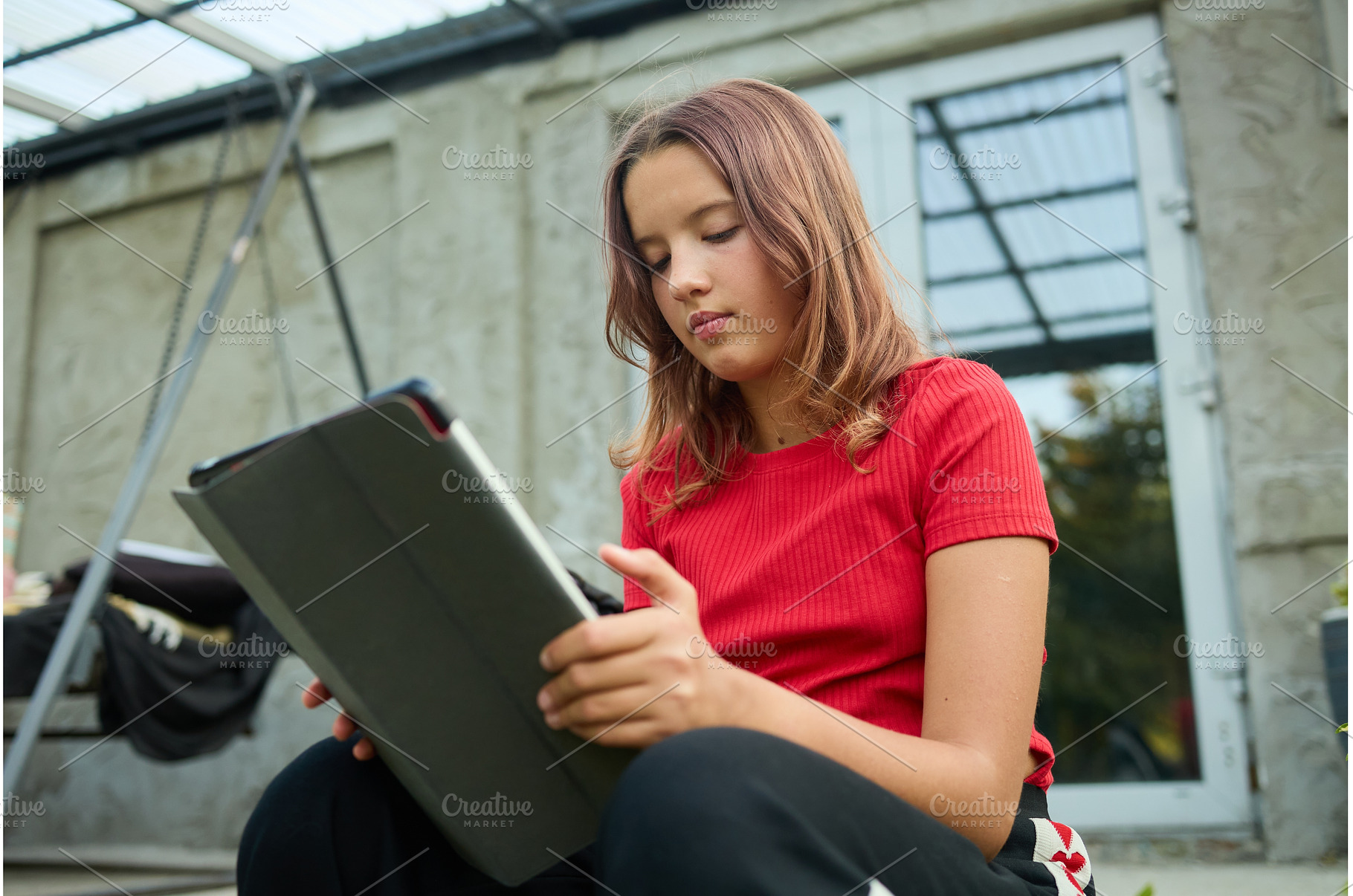 School girl uses tablet while, a School & Education Photo by IlliaBondarPhotography