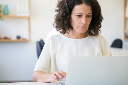 Woman using laptop in office