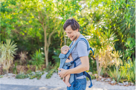 Young father walks in nature with