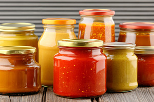 Glass jars filled with spicy pepper, a Photo by Dvoevnore photos