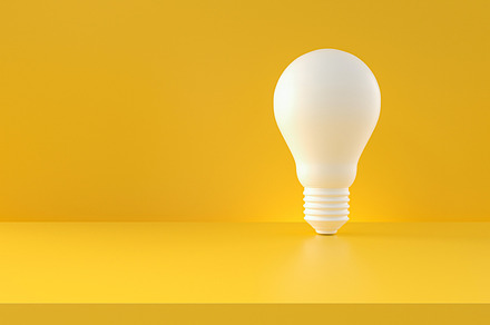 Light bulb white on yellow backgroun, a Business Photo by Zama Studio