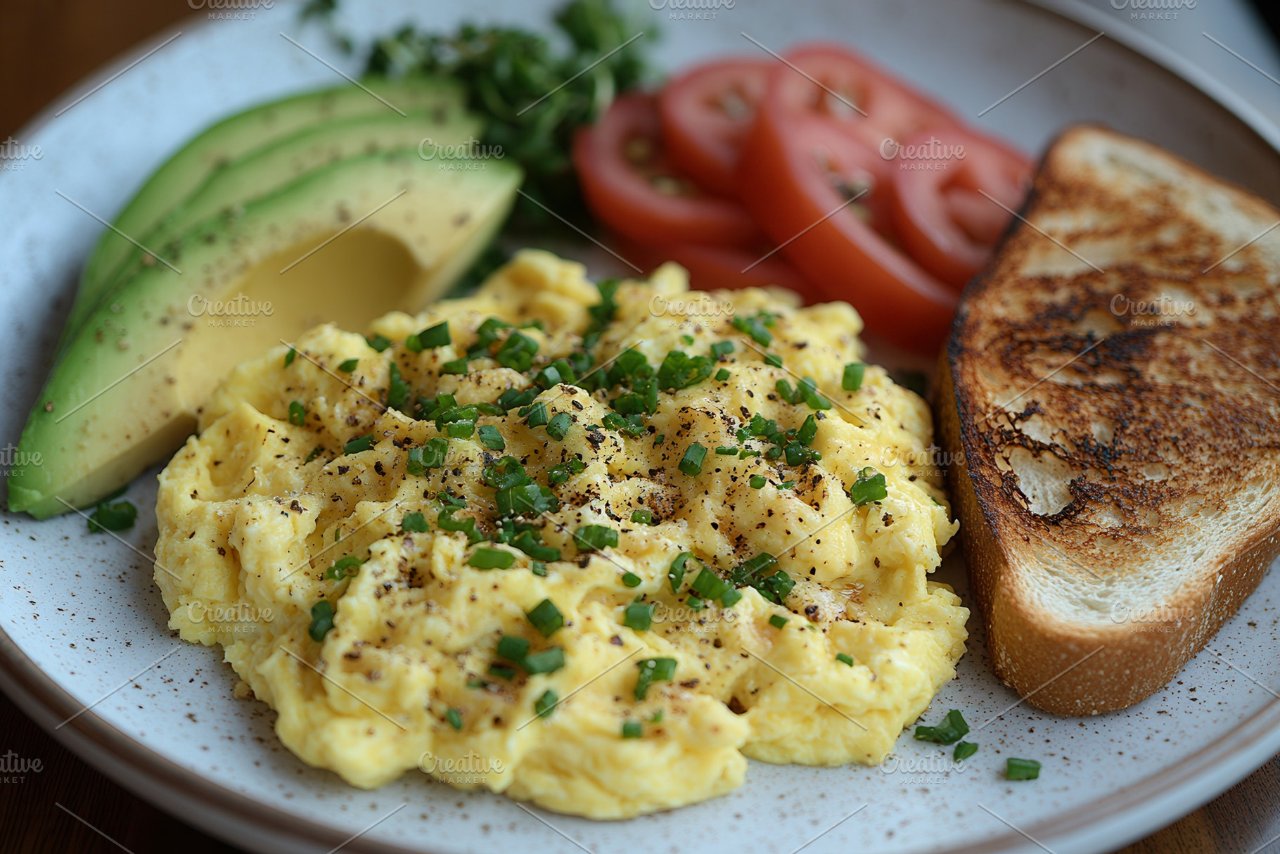 Creamy scrambled eggs with avocado,, a Photo by Tanuart