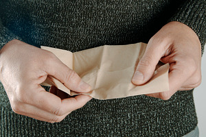 a man about to use a recycled paper tissue, a Photo by Nito