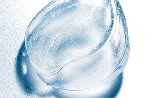 Transparent blue gel spreading on a white background, creating a, a Photo by Studio ANNA