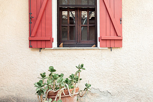 Wooden home window with red shutters, an Architecture Photo by BOOCYS