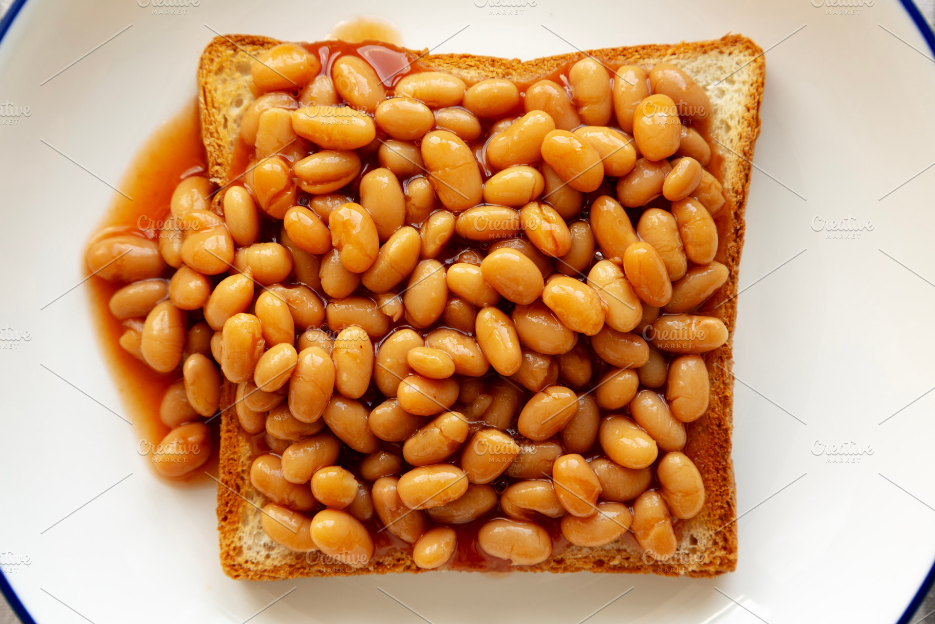 Homemade English Beans on Toast, top view. Close-up., a Food & Drink Photo by LiudmylaChuhunova