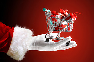 Santa's hand holding shopping cart full of gifts isolated red, a Person Photo by Davizro's Market