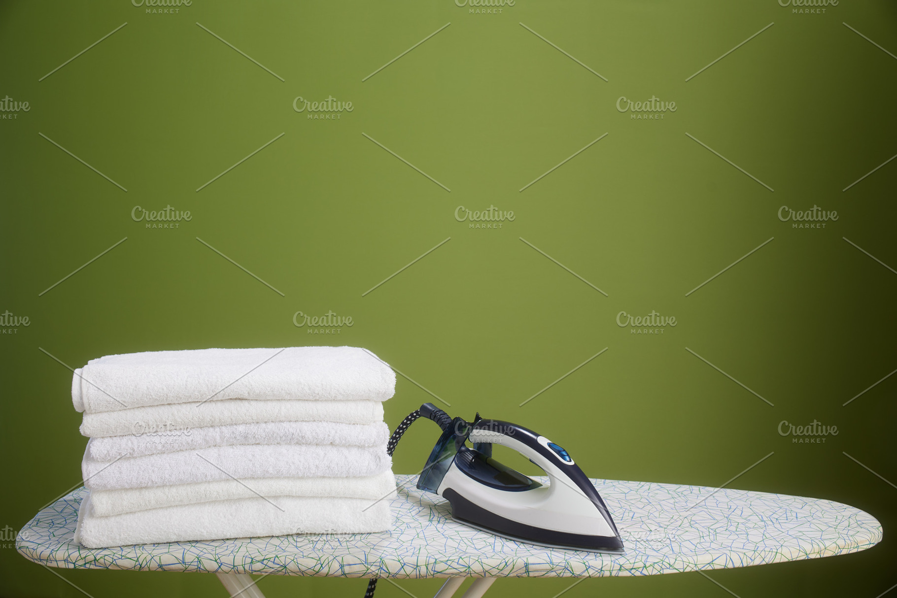 White towels, iron, and olive green wall, a Photo by Alliance Images