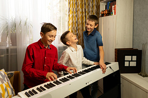 Group boys playing the piano, a School & Education Photo by Elena Vagengeim