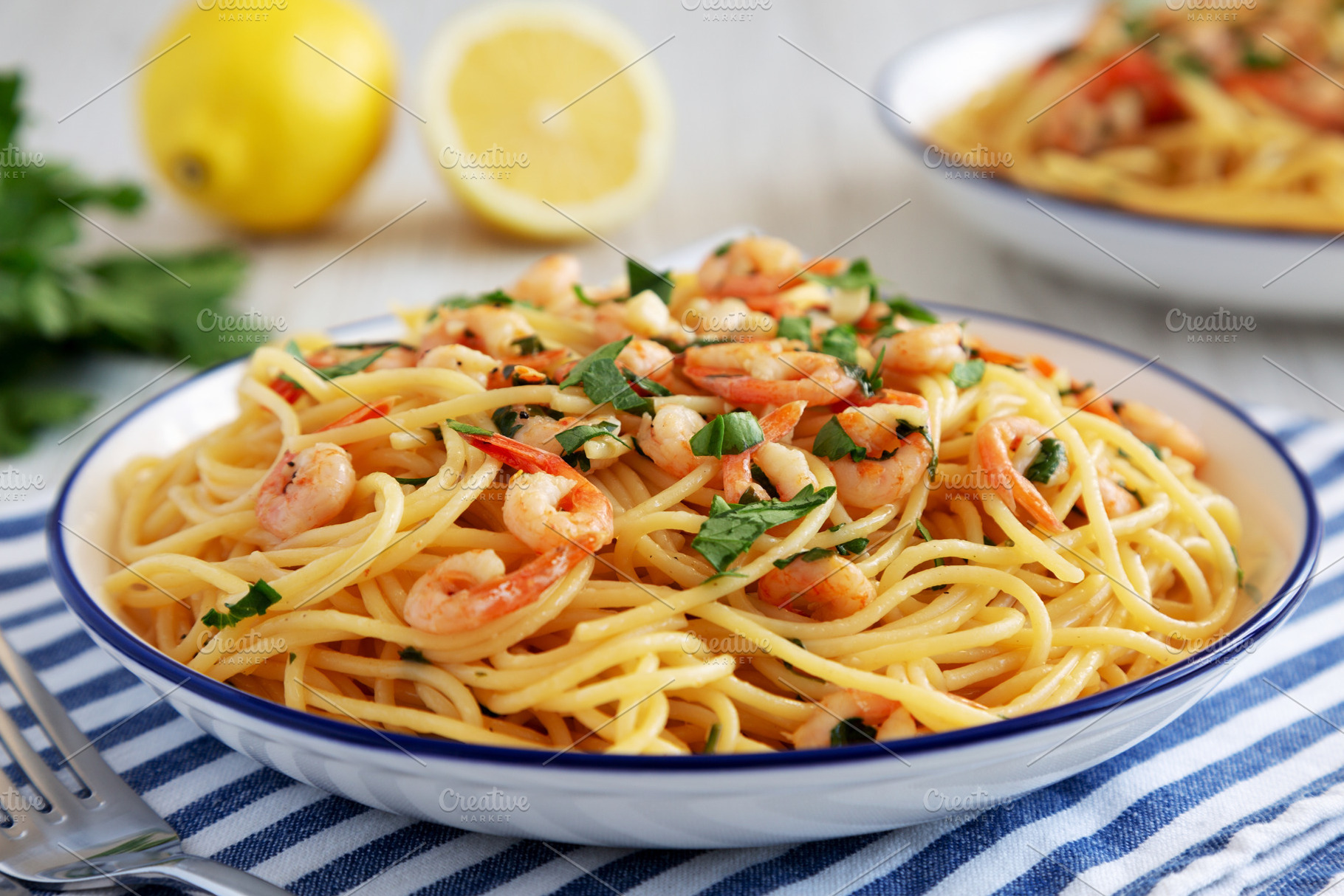 Homemade Garlic Shrimp Scampi with Parsley on a Plate, side view, a Food & Drink Photo by LiudmylaChuhunova