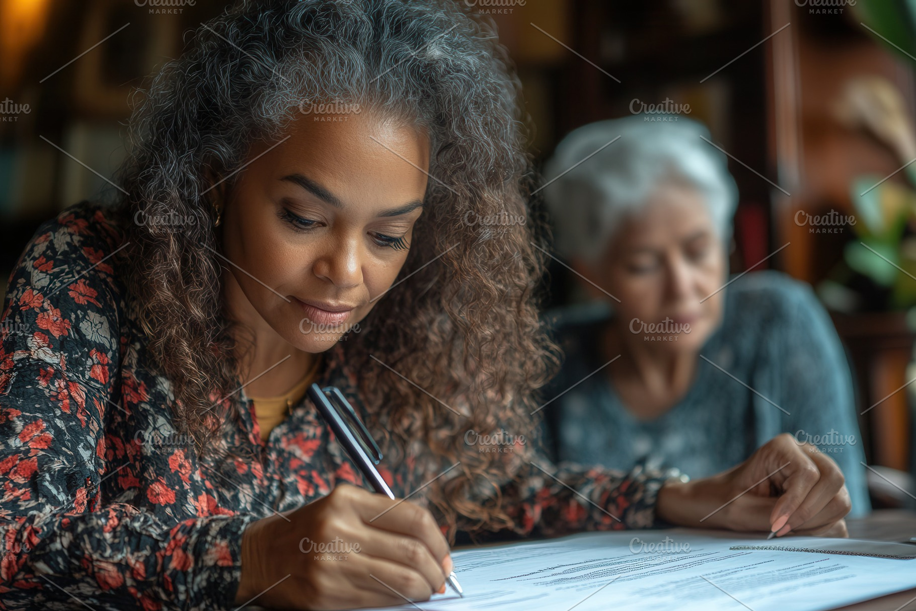 Young woman writing notes while elde, a Photo by Tanuart