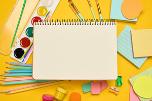 Open blank spiral notebook in the center, surrounded by school s, a School & Education Photo by ndanko
