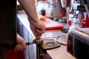 Making caffeine drink tamping coffee barista hand, a Person Photo by Photo Drive Studio