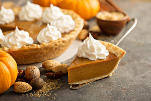Traditional pumpkin pie with whipped cream
