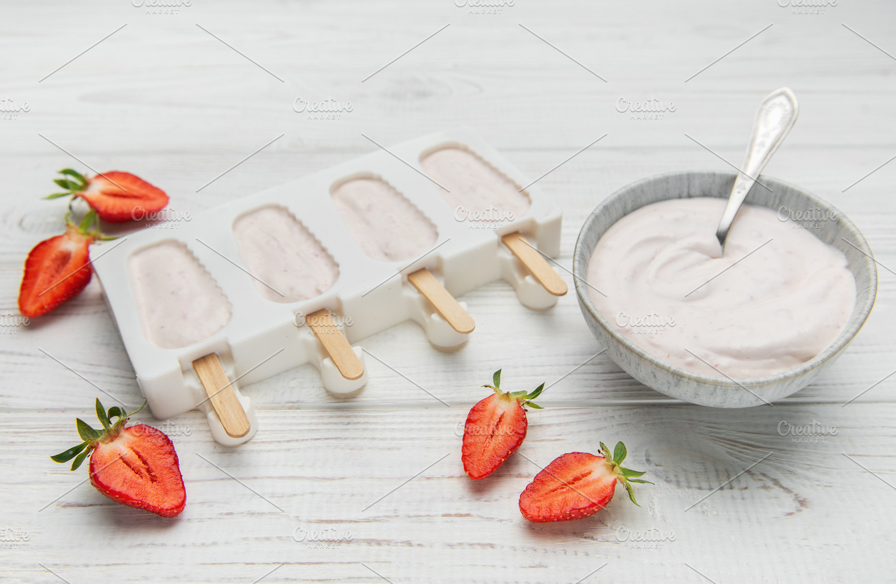 Homemade strawberry yogurt popsicles chilling in mold, a Food & Drink Photo by Olena Rudo
