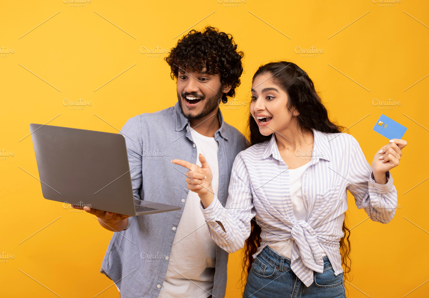 Joyful indian couple with laptop and credit card emotionally reacting to online, a Person Photo by Prostock-Studio