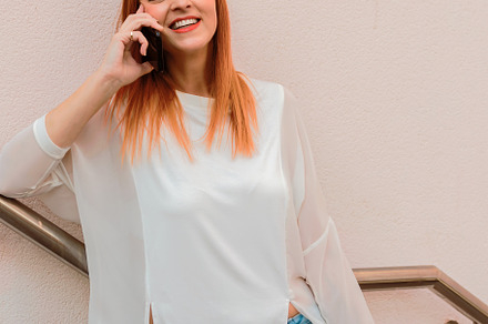 Smiling woman talking on a smartphon, a Person Photo by Perpis