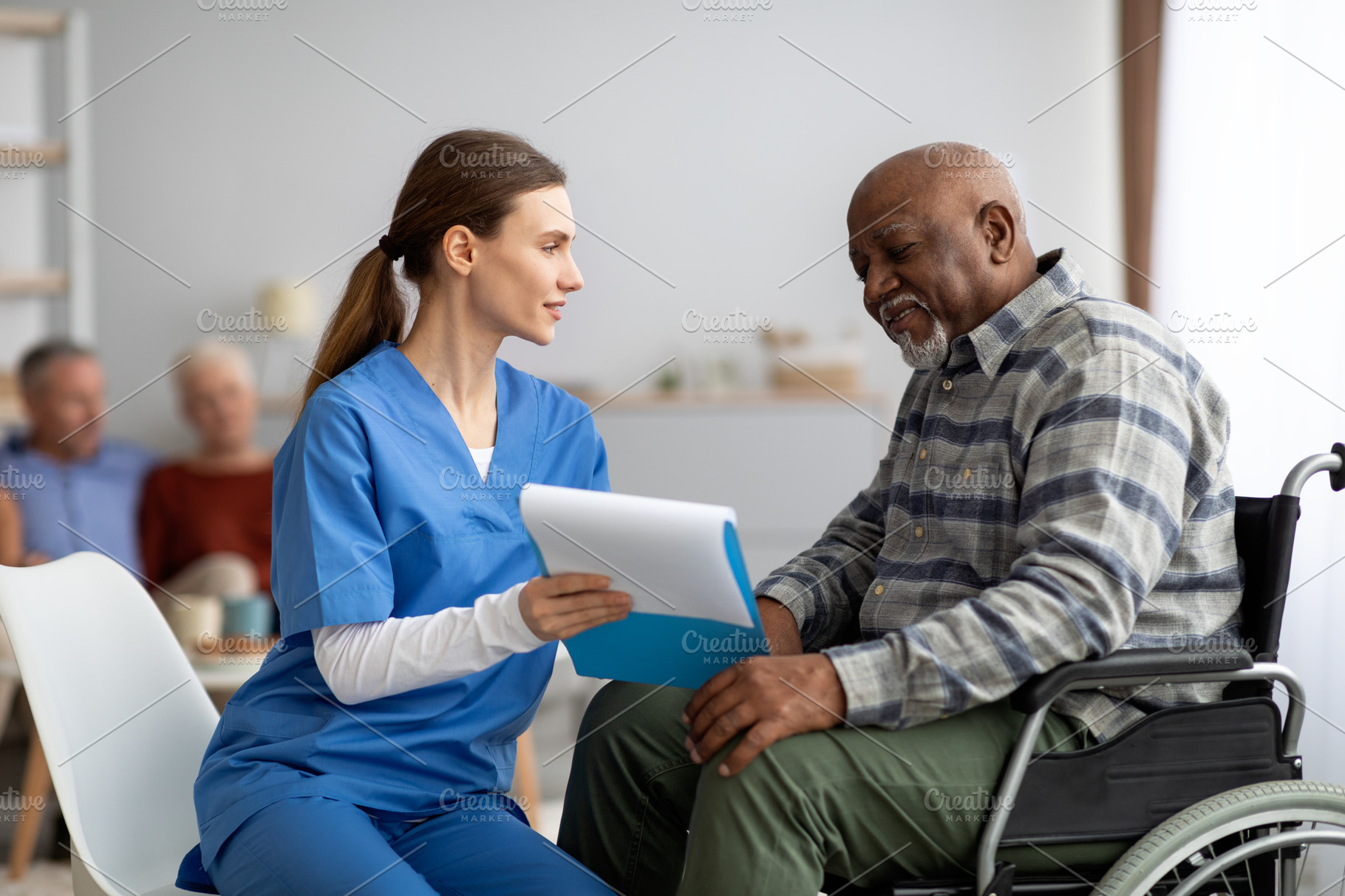 Pretty woman in workwear helping black senior man filling papers, a Photo by Prostock-Studio