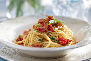 Spaghetti pasta with fresh tomato sauce and basil leaves, presen, a Photo by Studio ANNA