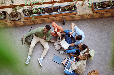 University phone selfie, peace sign and students working on research, college project or group education study. Knowledge learning, emoji gesture and top view of diversity friends on school floor, a Photo by Peopleimages.com