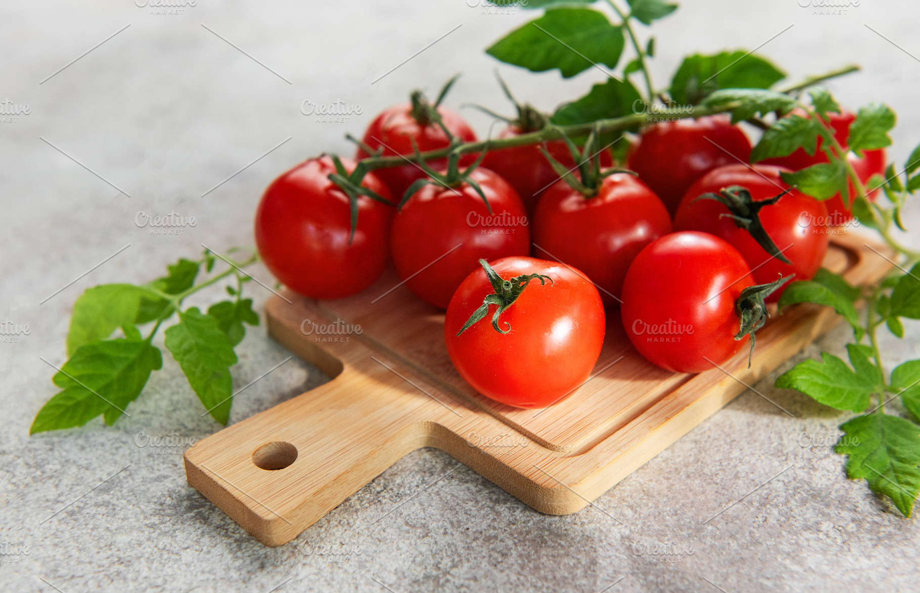 Fresh red cherry tomatoes on vine and cutting board, a Food & Drink Photo by Olena Rudo