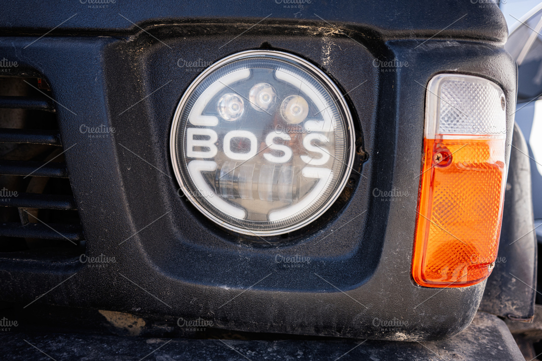 Front grilles and headlight of a vehicle captured in close-up view, a Photo by AS photostudio