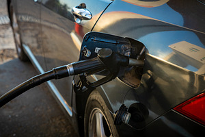Close-up view of a black car being refueled with gasoline at a modern gas stati, a Transportation Photo by Ales Munt