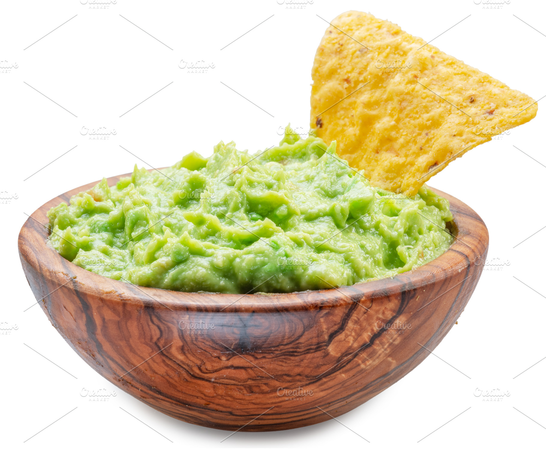 Guacamole bowl and corn chips dipped in it on white background., a Food & Drink Photo by Volff