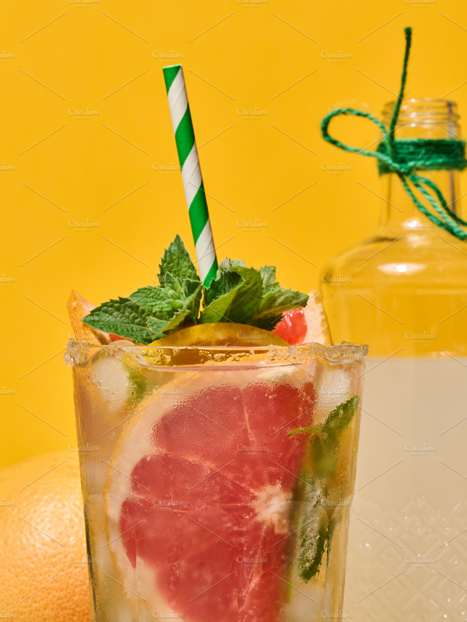 A clear glass with a cold drink, grapefruit slices, ice and mint, a Food & Drink Photo by ndanko