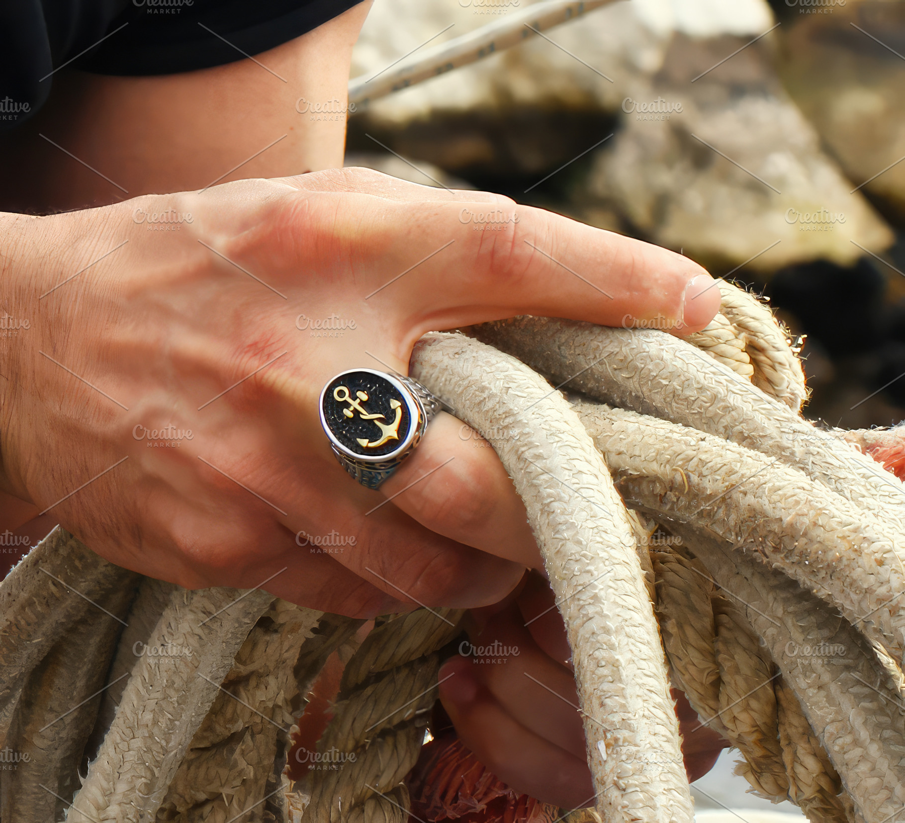 Sailor wearing a ring with an anchor while holding a rope, an Abstract Photo by Antonio Gravante Market