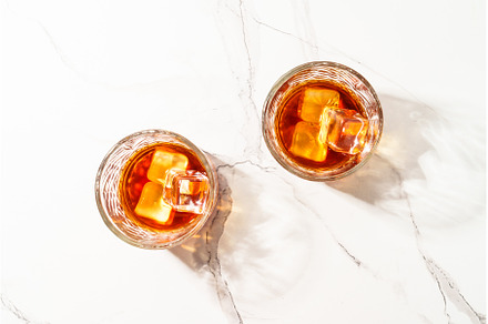 Whiskey with ice cube in the glass